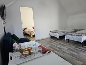 a room with two beds and a table with glasses at Villa Elena in Yanoshi