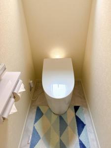a bathroom with a white toilet and a sink at HB Home TOKYO in Tokyo +1 photo
