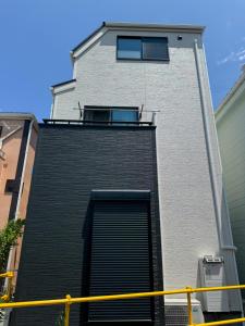 a building with a door and a window on it at HB Home TOKYO in Tokyo