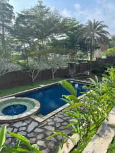 a swimming pool in a yard with a landscaping at YSR Himalaya Resort in Mantaak