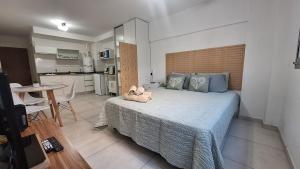 a bedroom with a bed with two stuffed animals on it at LoftPoint Rosario, Pileta, Solarium y Terraza con vista al Río in Rosario