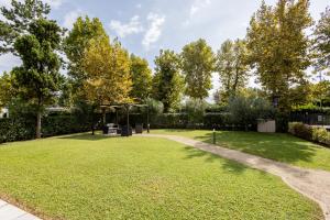 a garden with a gazebo and grass at Le Sabbie B&B - Camere in villino a 50mt dal mare in Riccione