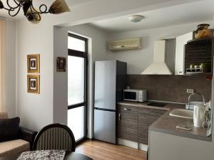 a kitchen with a refrigerator and a counter top at Apart di Landi in Ravda