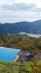 a row of blue solar panels on top of a hill at Cabaña - Macanal in Macanal