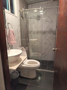a bathroom with a shower and a toilet and a sink at Cabaña - Macanal in Macanal