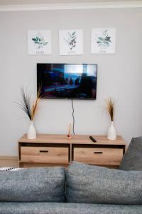 a living room with a couch and a flat screen tv at Selamu Self Catering in Walvis Bay