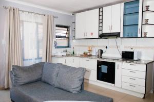 a living room with a couch in a kitchen at Selamu Self Catering in Walvis Bay