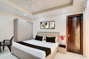 a bedroom with a large bed and a chair in it at Castle in Bharatpur
