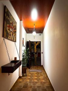 a hallway with a room with a piano and a door at Neska Polita Hostel in Juayúa