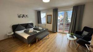 a living room with a bed and a couch at Pension Bergfried in Hallstatt