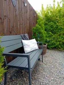 a bench with a pillow sitting on top of it at The Snug on The Brae in Inverness
