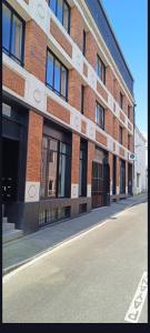 a brick building on the side of a street at Climatisé et atypique, bienvenue au LOFT-23 in Cholet