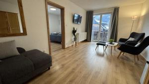 a living room with a couch and a table and chairs at Pension Bergfried in Hallstatt