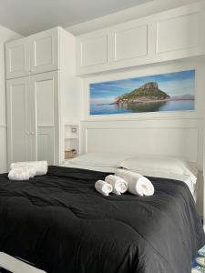 a bedroom with a bed with two towels on it at Hotel TEA - Praia a Mare in Praia a Mare
