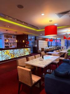 a restaurant with tables and chairs and a bar at Hotel Dream in Sofia