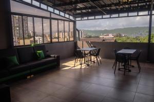 a restaurant with tables and chairs and a couch at Hotel Green Gold in Bucaramanga