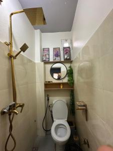 a small bathroom with a toilet and a mirror at Amazing apartment with traditional touch in Taskala