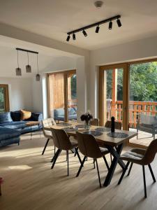 a living room with a table and chairs at Apartmán #7 Mariánská Hora in Albrechtice v Jizerských horách