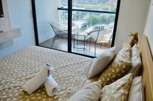 a bedroom with a bed with two stuffed animals on it at Samaia Loft in Santa Marta