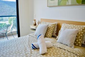 a bed with a sock on it with pillows at Samaia Loft in Santa Marta