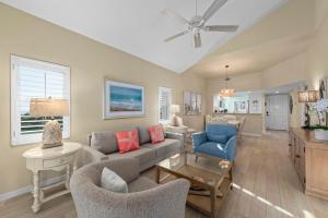 a living room with a couch and chairs at Shell Island Beach Club #5D in Sanibel