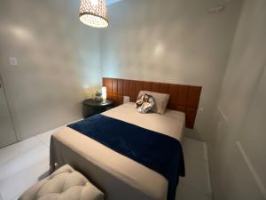 a small bedroom with a bed and a chair at Vida & Brisa Pousada in Pelotas +48 photos