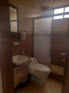 a bathroom with a toilet and a sink and a shower at Hotel Stella blu in Manta +27 photos