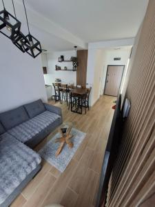 a living room with a couch and a table at Jahorina Lux in Jahorina