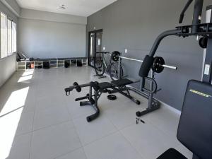 a gym with several exercise equipment in a room at Departamento 1 dormitorio con piscina in Fernando de la Mora