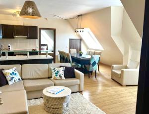 a living room and kitchen with a couch and a table at Luxury Chalet in Borovets, Rila Views & Fireplace in Borovets