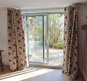 an open glass door with curtains in a room at Studio Nature in Marboz +5 photos