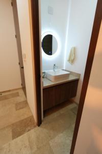 a bathroom with a sink and a mirror at Casa Morrocoy con alberca privada y 3 habitaciones in Cholul +12 photos