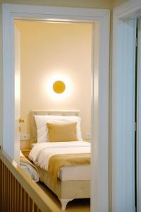 a bedroom with a white bed with a light above it at LUXIA PRIVATE ESTATE Sauna & Pool x Jacuzzi with Fireplace outdoor lounge in Bihać +40 photos