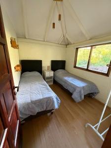 a bedroom with two beds in a tent at Casa Playa Mansa in Mina Clavero +55 photos