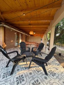 a group of chairs sitting on a patio at Casa Playa Mansa in Mina Clavero