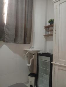 a bathroom with a sink and a shower curtain at Cantinho in Rio de Janeiro