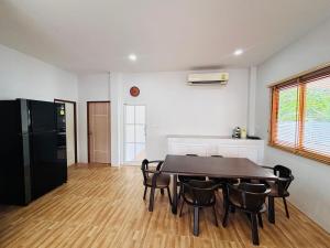 a kitchen and dining room with a table and chairs at AAA villa Aonang Krabi in Ao Nang 
