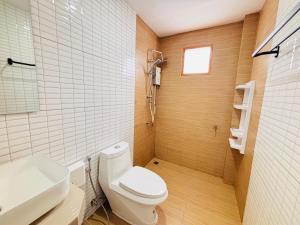 a bathroom with a white toilet and a sink at AAA villa Aonang Krabi in Ao Nang 