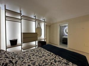 a bedroom with a bed and a dresser and a mirror at Romantico bilocale ad Ortigia in Syracuse