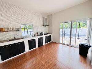a kitchen with a hard wood floor and a counter top at AAA villa Aonang Krabi in Ao Nang  +10 photos