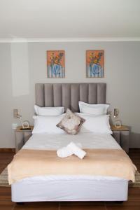 a bedroom with a large bed with a towel on it at Selamu Self Catering in Walvis Bay