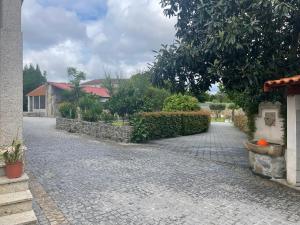 a cobblestone driveway in front of a house at Quinta do Sobrado in Braga