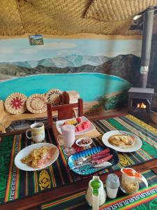 a breakfast table with plates of food and drinks at COTOPAXI Wasi Andina Lodge in Latacunga