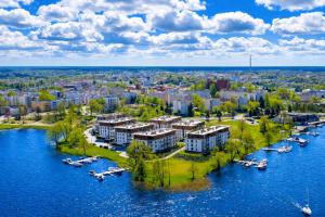 an aerial view of a city with boats in the water at Marina Luna - widok na jezioro, parking podziemny, winda, Netflix, Max in Iława