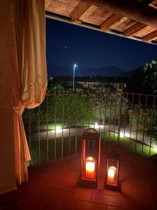 two lights sitting on a patio at night at Dimora Bollicine in Colombaro
