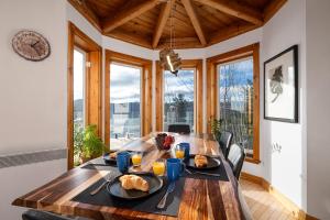 a dining room with a wooden table with food on it at Havre sur la Baie in Baie-Saint-Paul