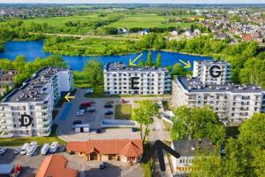 an aerial view of a city with a river and buildings at River View - widok na wodę, parking w hali, winda, 3pok i 5 łóżek, klima, Netflix i Max, centrum in Iława