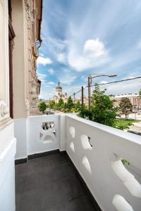 a balcony with a view of a city at Palazzo Bellariva Dimora in Cluj-Napoca