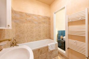 a bathroom with a tub and a sink at Palazzo Bellariva Dimora in Cluj-Napoca +66 photos