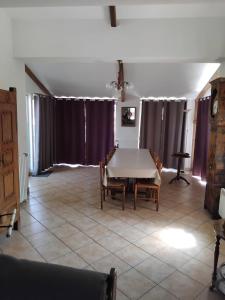 a dining room with a table and chairs at Maison de caractère in Saint-Vert +13 photos